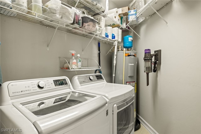 laundry area with electric water heater and washing machine and dryer