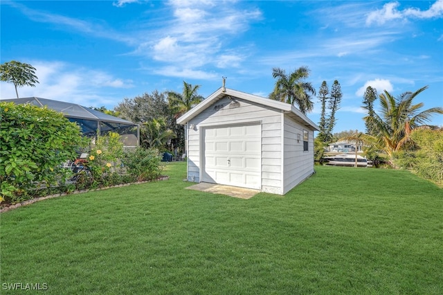 garage featuring a lawn