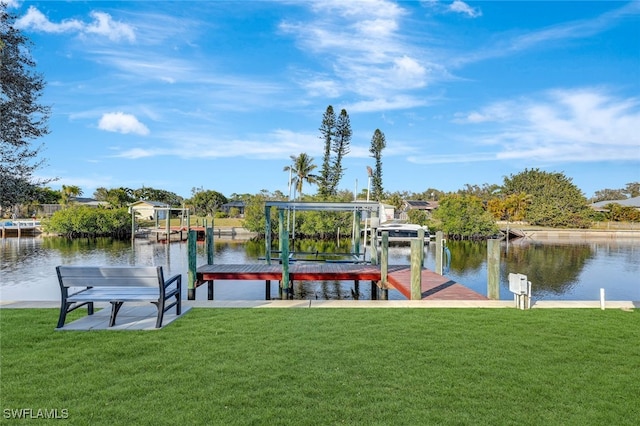 view of dock featuring a water view and a yard