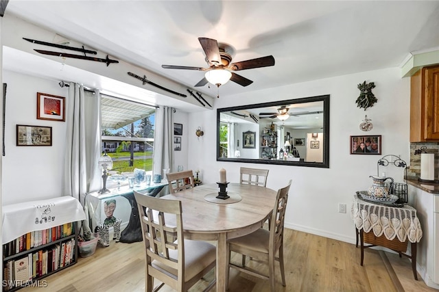 dining area featuring ceiling fan and light wood-type flooring