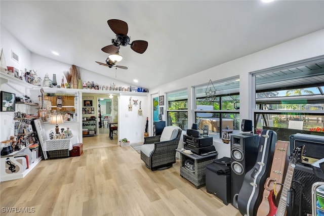 living room with lofted ceiling, light hardwood / wood-style flooring, and ceiling fan