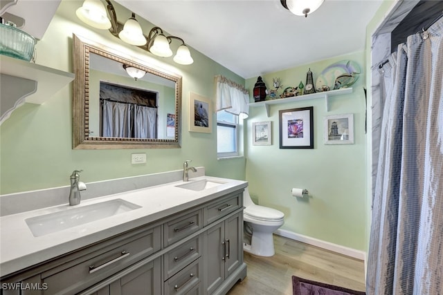 bathroom featuring vanity, toilet, and hardwood / wood-style floors