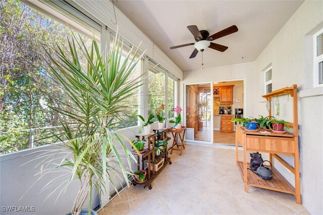 sunroom featuring ceiling fan