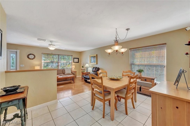 715 96th Ave N, Naples, FL 34108 - dining room featuring light tile patterned floors, a chandelier, and ceiling fan