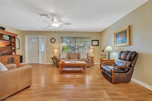 living room with ceiling fan and light hardwood / wood-style flooring