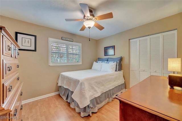 715 96th Ave N, Naples, FL 34108 - bedroom with light wood-style flooring, a closet, baseboards, and a ceiling fan