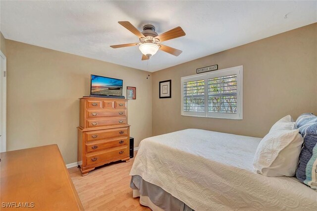 bedroom with ceiling fan and light wood-type flooring