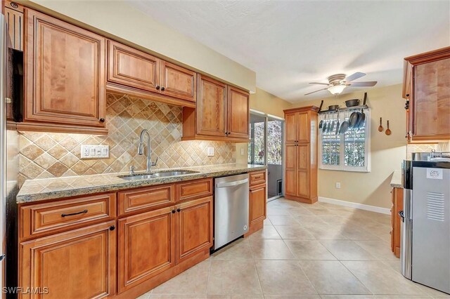 kitchen with light tile patterned flooring, dishwasher, sink, decorative backsplash, and ceiling fan