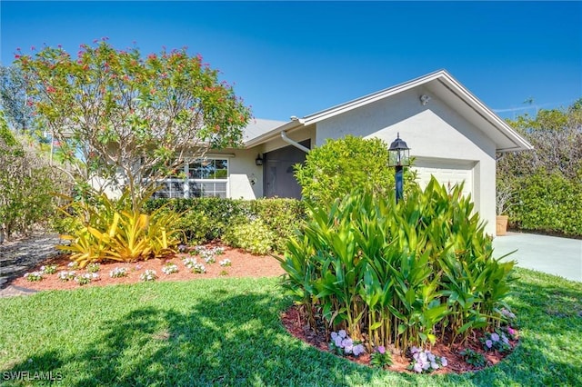 715 96th Ave N, Naples, FL 34108 - view of side of home featuring stucco siding, an attached garage, a lawn, and driveway