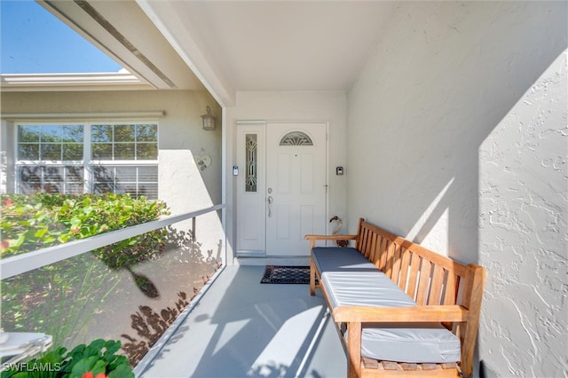 715 96th Ave N, Naples, FL 34108 - property entrance with stucco siding and a balcony