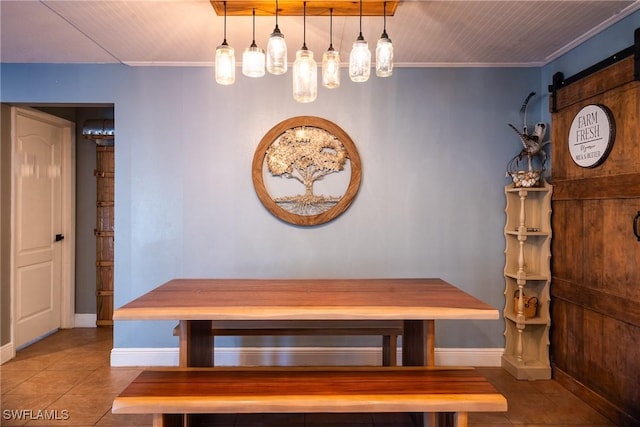 unfurnished dining area with crown molding, a barn door, and tile patterned floors