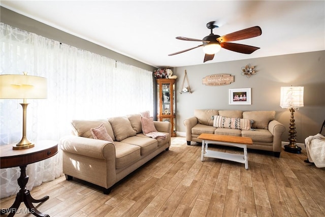 living room with ceiling fan and light hardwood / wood-style floors