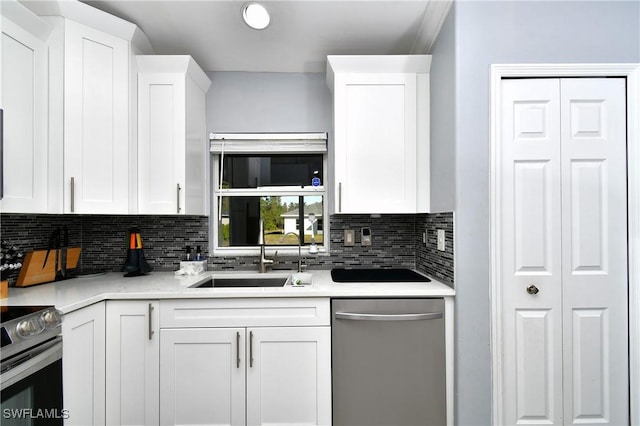 kitchen featuring white cabinetry, sink, decorative backsplash, and appliances with stainless steel finishes