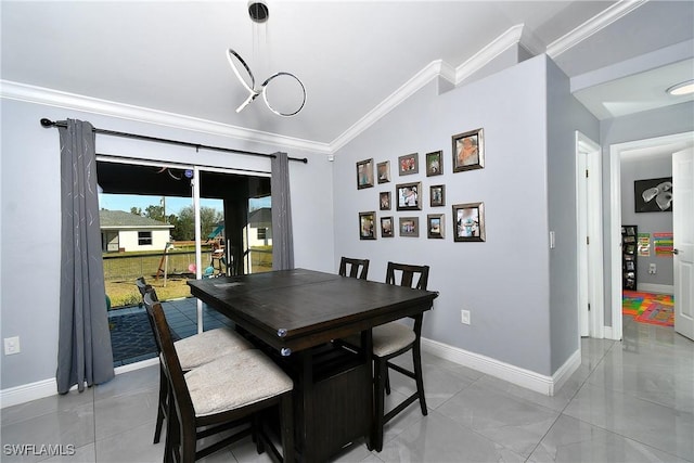 dining room with crown molding, lofted ceiling, and light tile patterned flooring