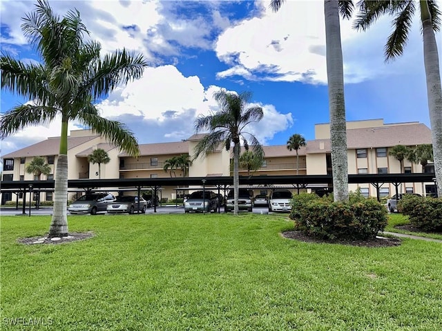 view of building exterior featuring covered parking