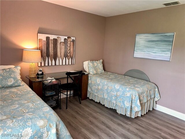 bedroom featuring dark hardwood / wood-style flooring