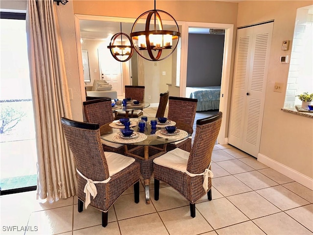 dining space with light tile patterned floors and a notable chandelier