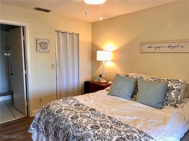 bedroom featuring dark hardwood / wood-style flooring and a closet