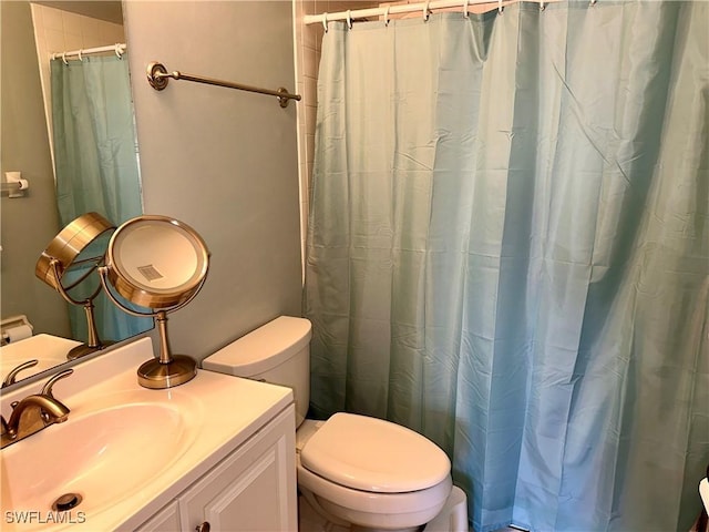 bathroom with vanity, toilet, and a shower with shower curtain