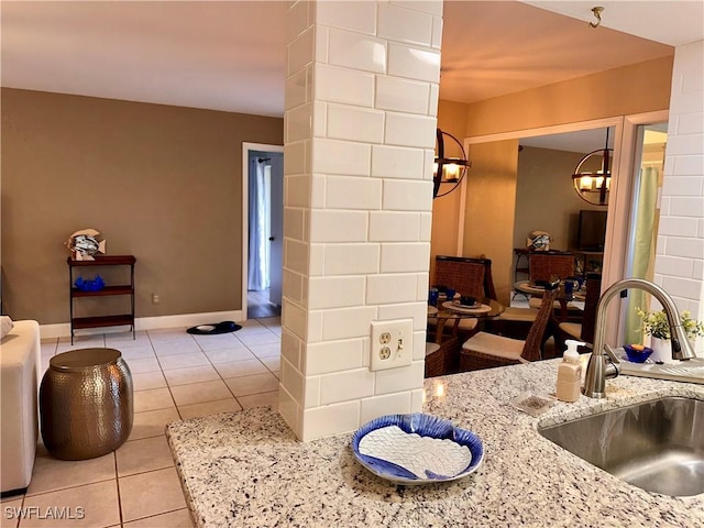 bathroom with baseboards, a sink, and tile patterned floors