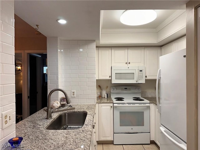 kitchen featuring white appliances, a sink, white cabinetry, and crown molding