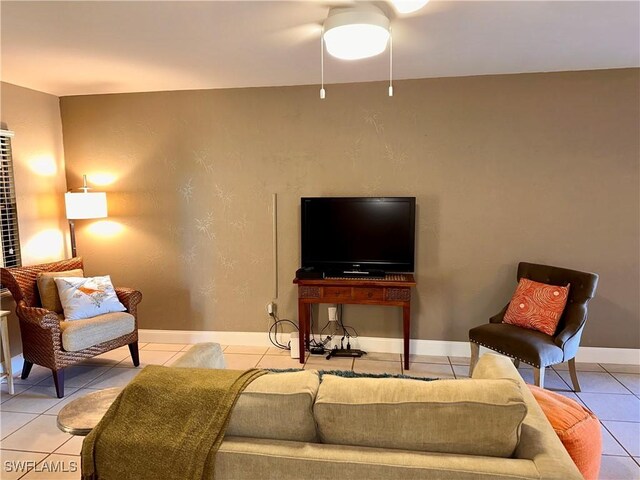 living area with light tile patterned floors and baseboards