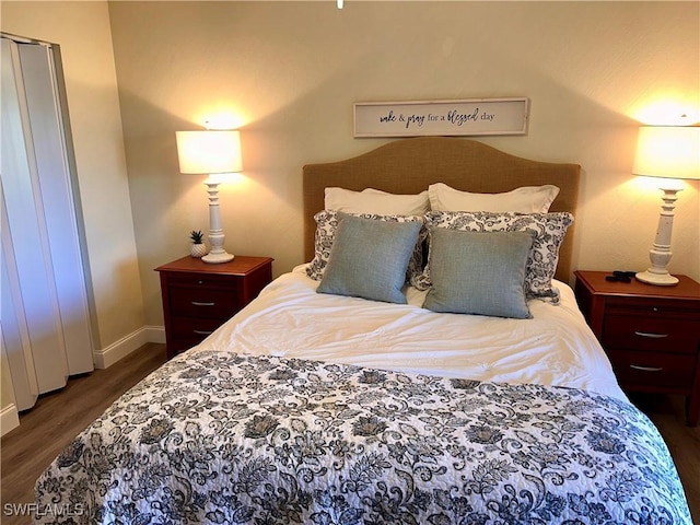 bedroom featuring baseboards and wood finished floors