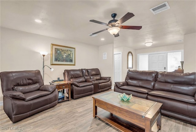 living room with light hardwood / wood-style floors and ceiling fan