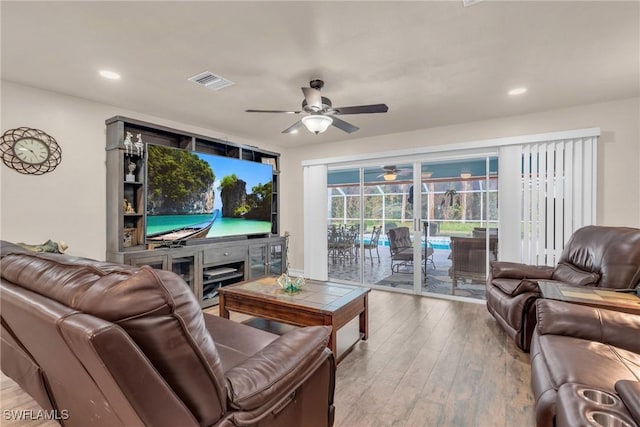 living room with wood-type flooring and ceiling fan