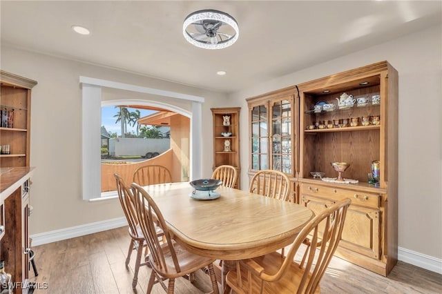 dining room with light hardwood / wood-style flooring and ceiling fan