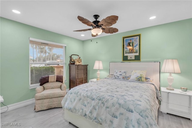 bedroom with ceiling fan and light hardwood / wood-style flooring