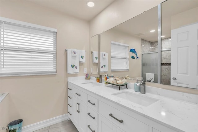 bathroom featuring an enclosed shower and vanity