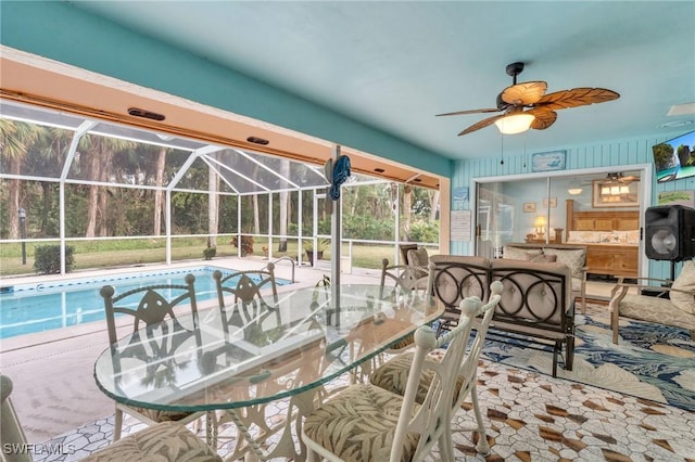 exterior space with a patio, ceiling fan, and glass enclosure