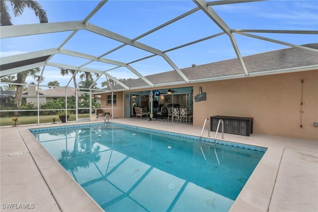 pool with a patio area and glass enclosure