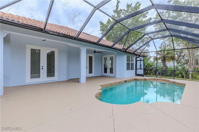 view of pool with a patio, a lanai, and french doors