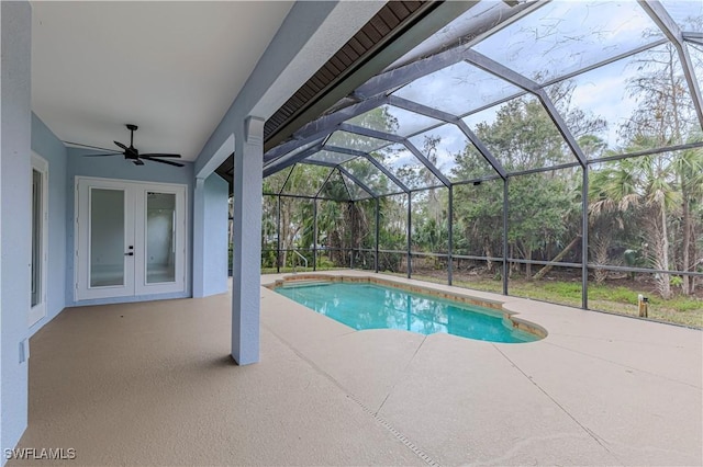 view of pool with a patio, ceiling fan, glass enclosure, and french doors