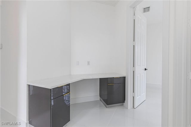 4273 18th St NE, Naples, FL 34120 - unfurnished office featuring built in study area, light tile patterned flooring, and baseboards