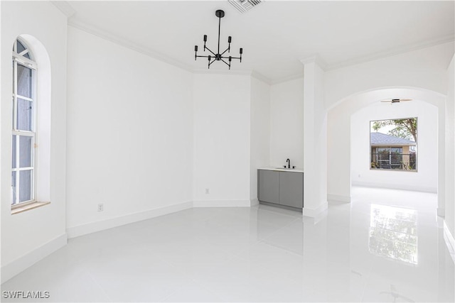 4273 18th St NE, Naples, FL 34120 - empty room featuring arched walkways, a chandelier, ornamental molding, light tile patterned floors, and a sink