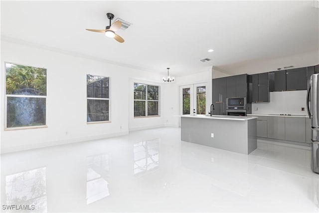 4273 18th St NE, Naples, FL 34120 - kitchen featuring appliances with stainless steel finishes, a sink, a ceiling fan, modern cabinets, and light countertops