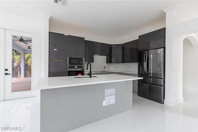 4273 18th St NE, Naples, FL 34120 - kitchen featuring black appliances, dark cabinetry, modern cabinets, light countertops, and a sink