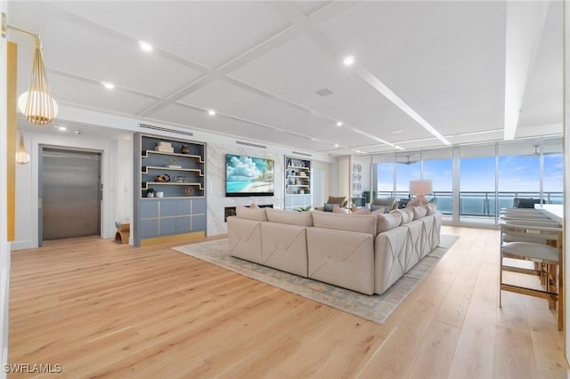 living room featuring elevator, built in features, expansive windows, coffered ceiling, and light wood-type flooring