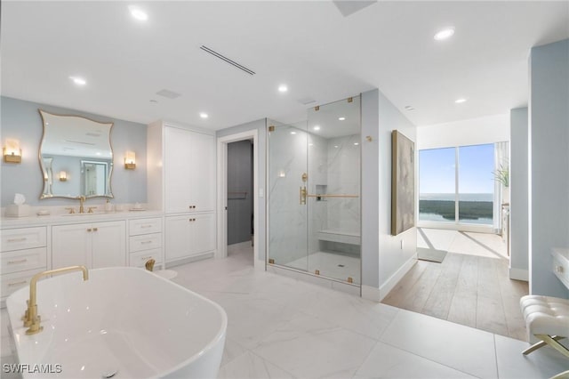 bathroom featuring vanity and shower with separate bathtub