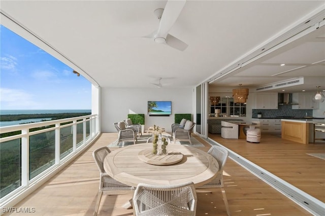 balcony with a water view and ceiling fan