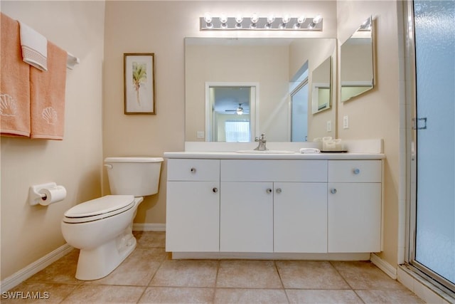 bathroom featuring vanity, toilet, tile patterned floors, and walk in shower