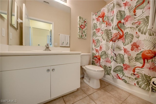 full bathroom featuring vanity, tile patterned floors, toilet, and shower / bath combo with shower curtain