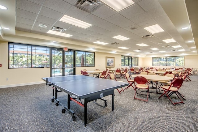 game room featuring a drop ceiling, plenty of natural light, and carpet flooring