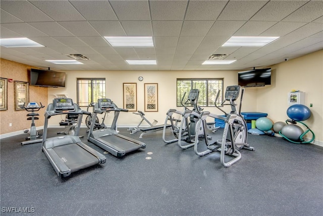 exercise room with a paneled ceiling