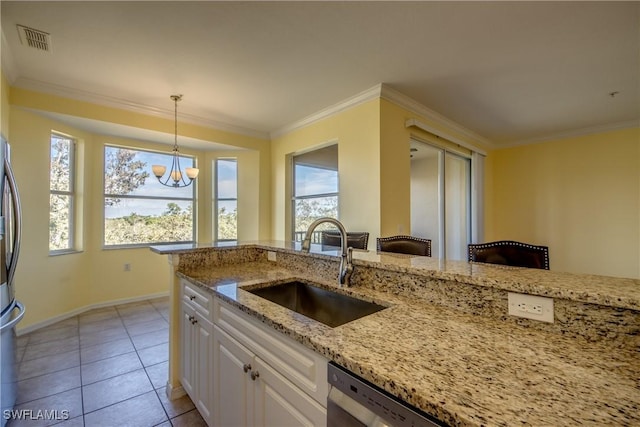 kitchen featuring sink, hanging light fixtures, ornamental molding, light stone countertops, and white cabinets