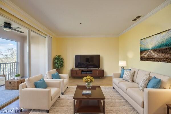 living room with crown molding, ceiling fan, and light hardwood / wood-style floors