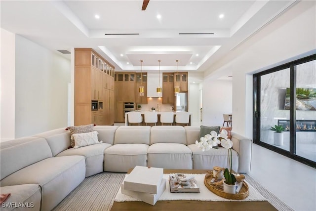 living room featuring a raised ceiling